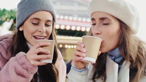 Handheld-view-of-friends-drinking-hot-coffee-to-warm-up