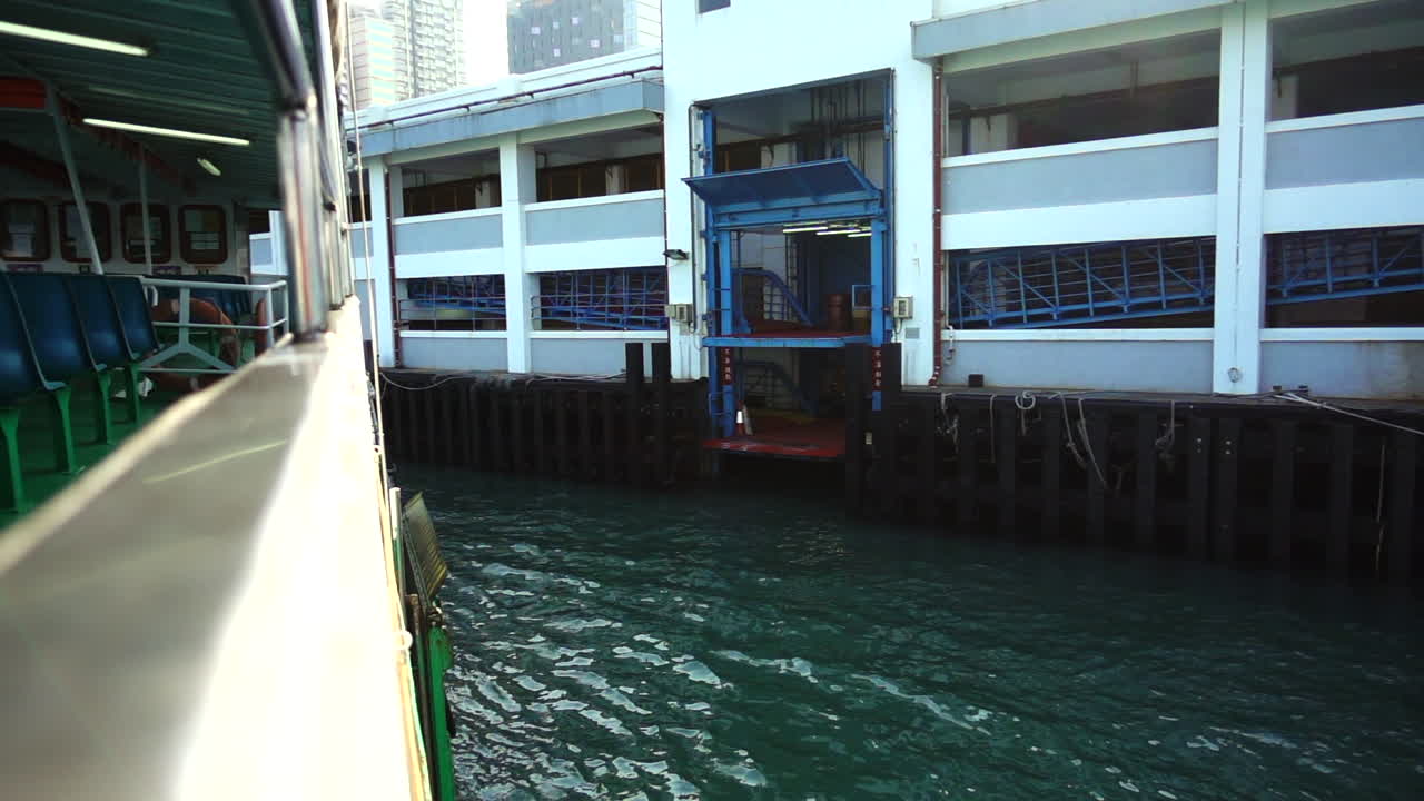 A ship is docking to the ferry pier in Hong Kong. with slow motion