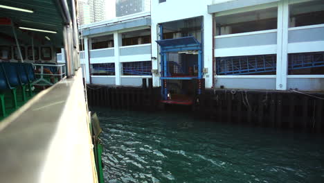 a ship is docking to the ferry pier in hong kong. with slow motion