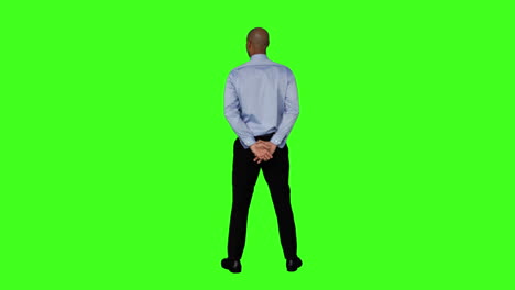 businessman standing with hands behind back