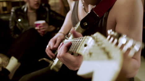 musician playing the electric guitar in studio