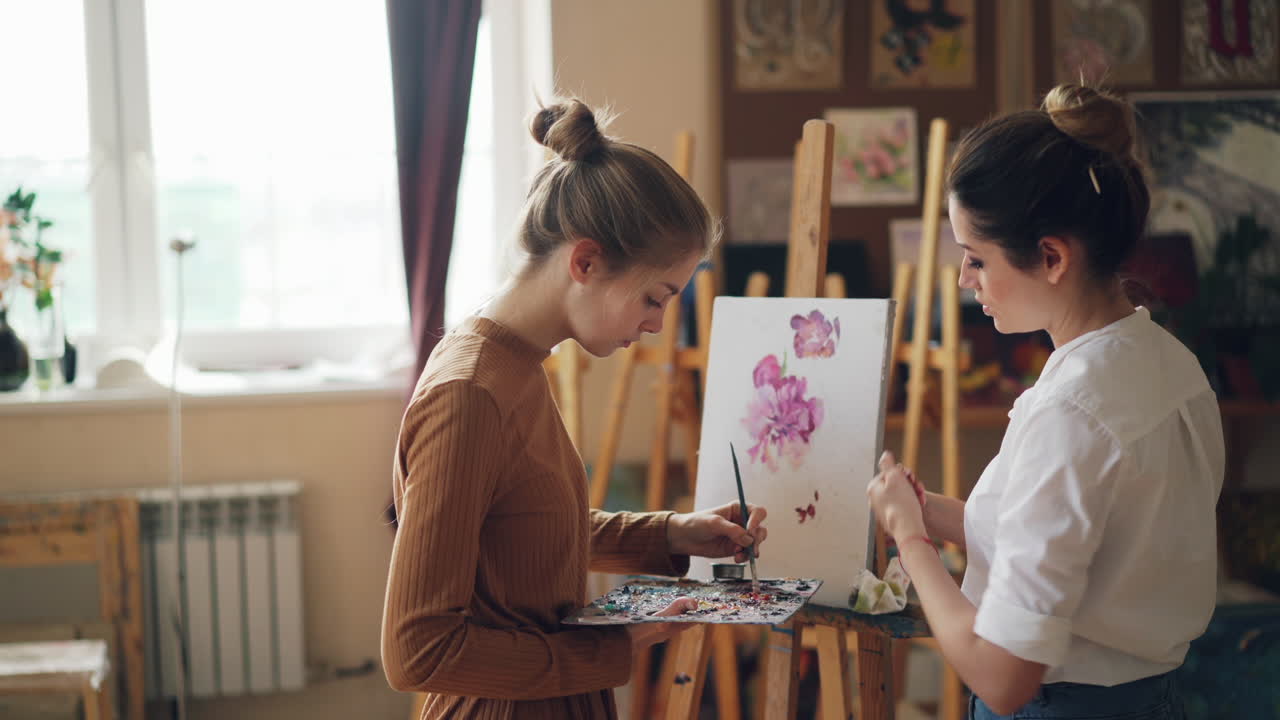 Two women painting in an art studio