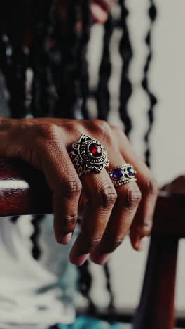 close-up of a hand wearing ornate gemstone rings