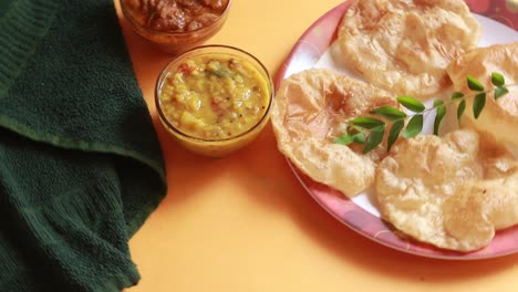 rotation chole bhature or chick pea curry and fried puri served in terracotta crockery over yellow background