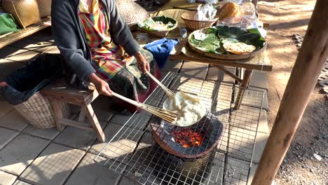 crafting rice crackers over open flame in thailand