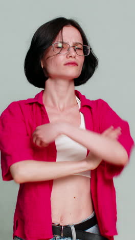 woman pointing at her eyes then at camera making humorous gesture indicating i am watching you now