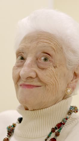 old woman smiling looking at the camera sitting on geriatric