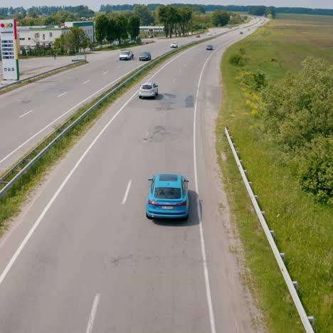 Blue audi on a highway. Luxury electric car driving slowly. Presentation of e-tron automobile. Aerial view
