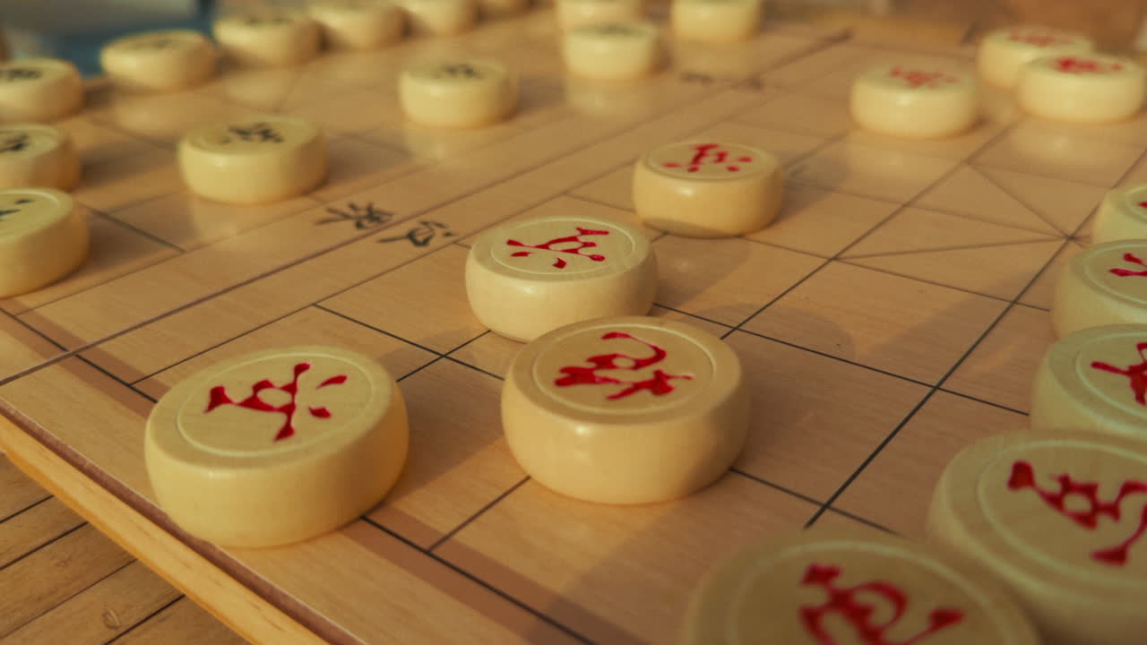 Chess game pieces on a wooden board with Chinese characters, captured in Wuzhen, China