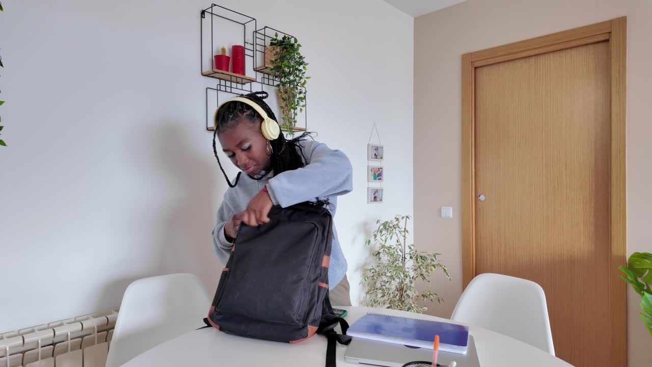 Woman Packing Backpack Indoors