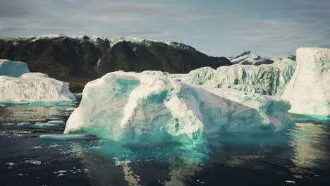 snow-capped mountains against the blue ocean in antarctica