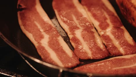 slow pan of vegan bacon cooking and bubbling