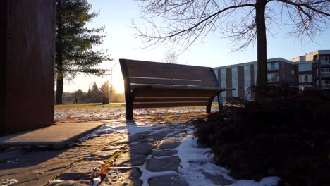 pan shot of a benchpark in winter by sunset