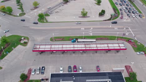 crane shot of tanker semi truck unloading gasolie and diesel at gas station