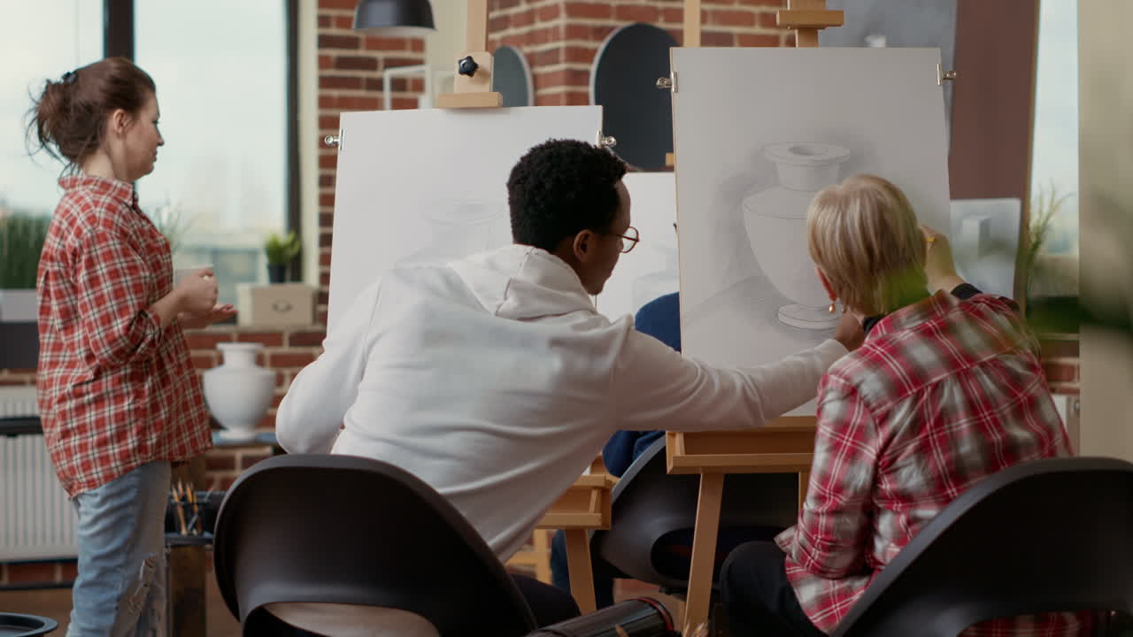 Multiethnic team of people working together to draw vase model