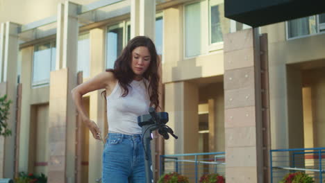 brunette woman scanning code renting scooter on street. asian girl paying bike.