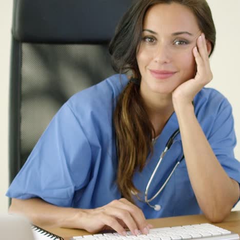 Serious-female-doctor-at-laptop-computer