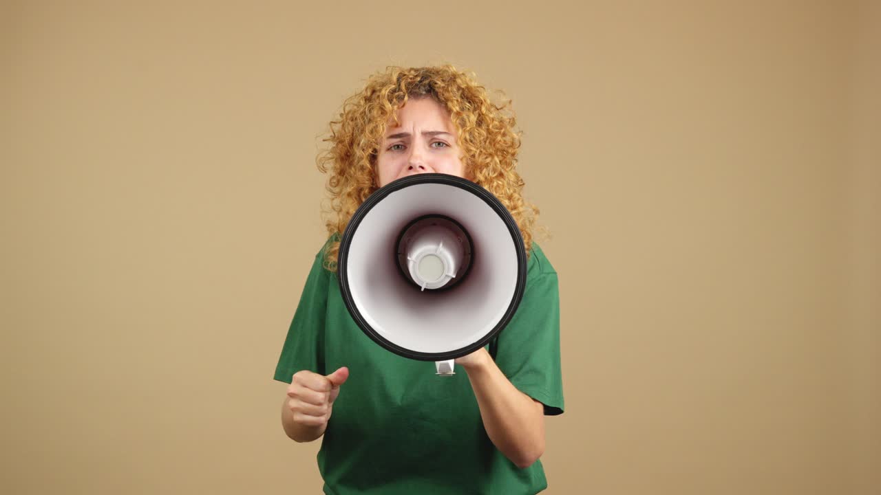 Young Woman with Curly Hair Shouting into a Megaphone