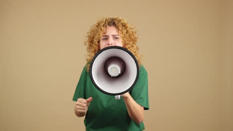 young woman with curly hair shouting into a megaphone