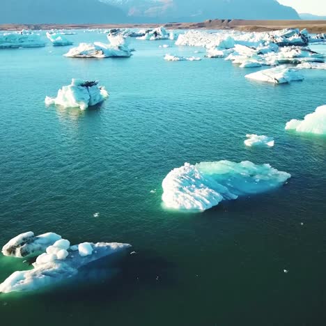 Drohnenantenne-über-Eisbergen,-Die-Sich-In-Einer-Gletscherbucht-Jökulsárlón-Gletscherlagune-Island-Bewegen,-Was-Auf-Die-Globale-Erwärmung-Hindeutet