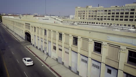 an aerial view of a large industrial building and a street in an urban area