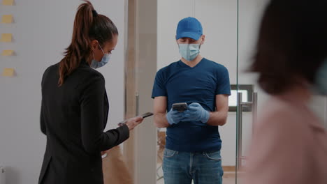 businesswoman with face mask against coronavirus paying takeaway food order