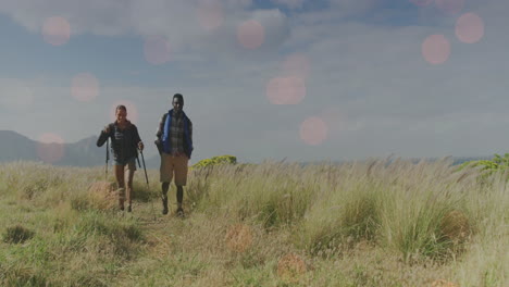 animation of light spots over disabled biracial man and woman walking in mountains