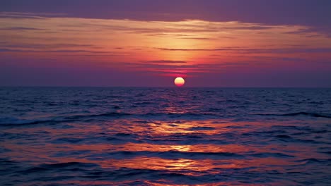 A stunning sunset over the ocean captured from a low-angle, perfect for a serene video backdrop