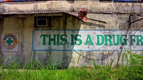 An-abandoned-building-displays-the-phrase-"This-is-a-drug-free-workplace