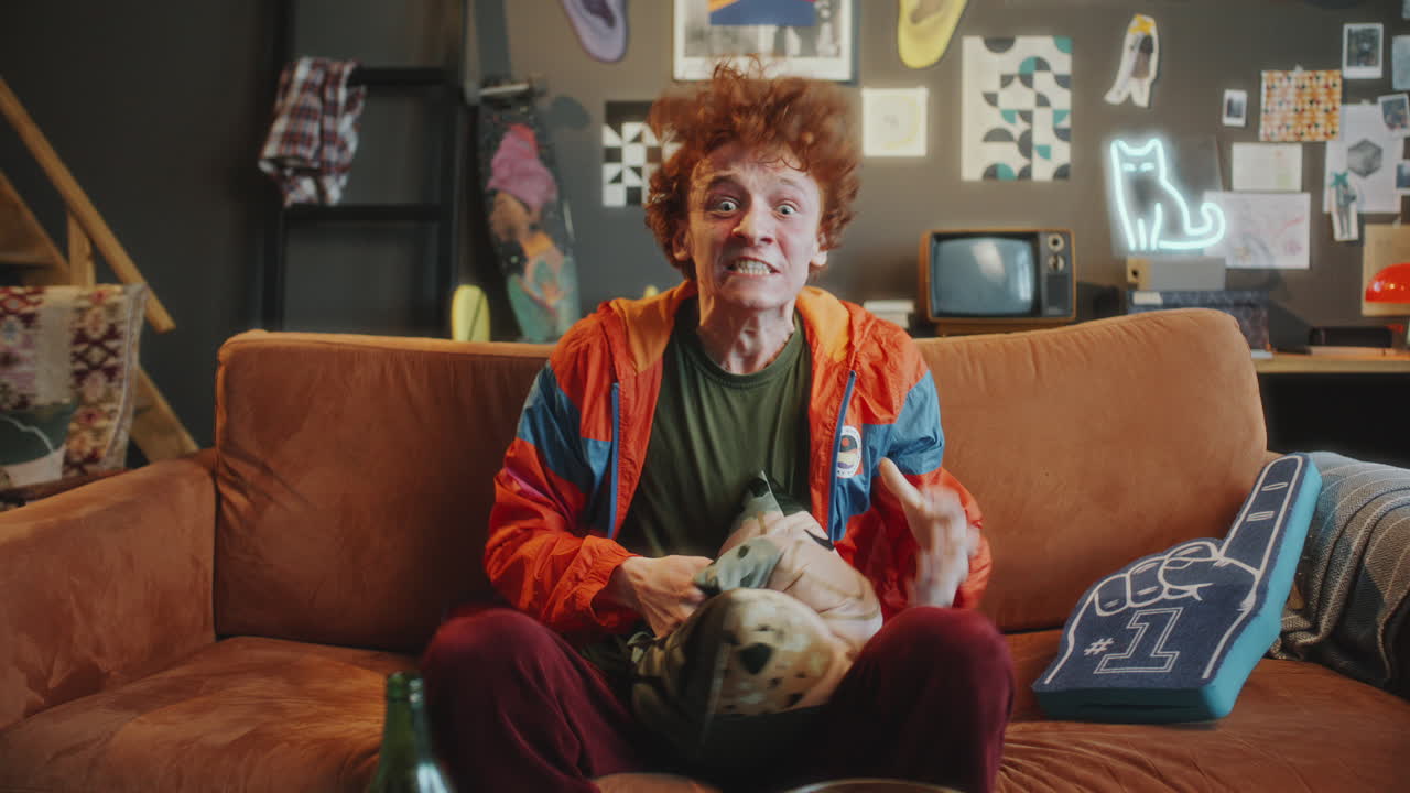 Heartbroken Sports Fan Watching TV Match and Reacting to Loss with Frustration