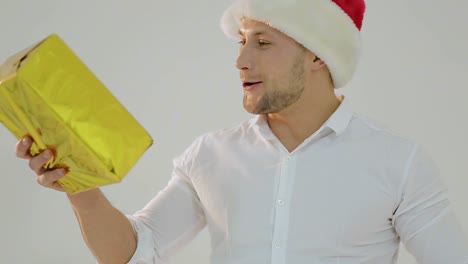 Happy Man Unboxing a Golden Christmas Gift