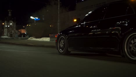 black car at night in city street