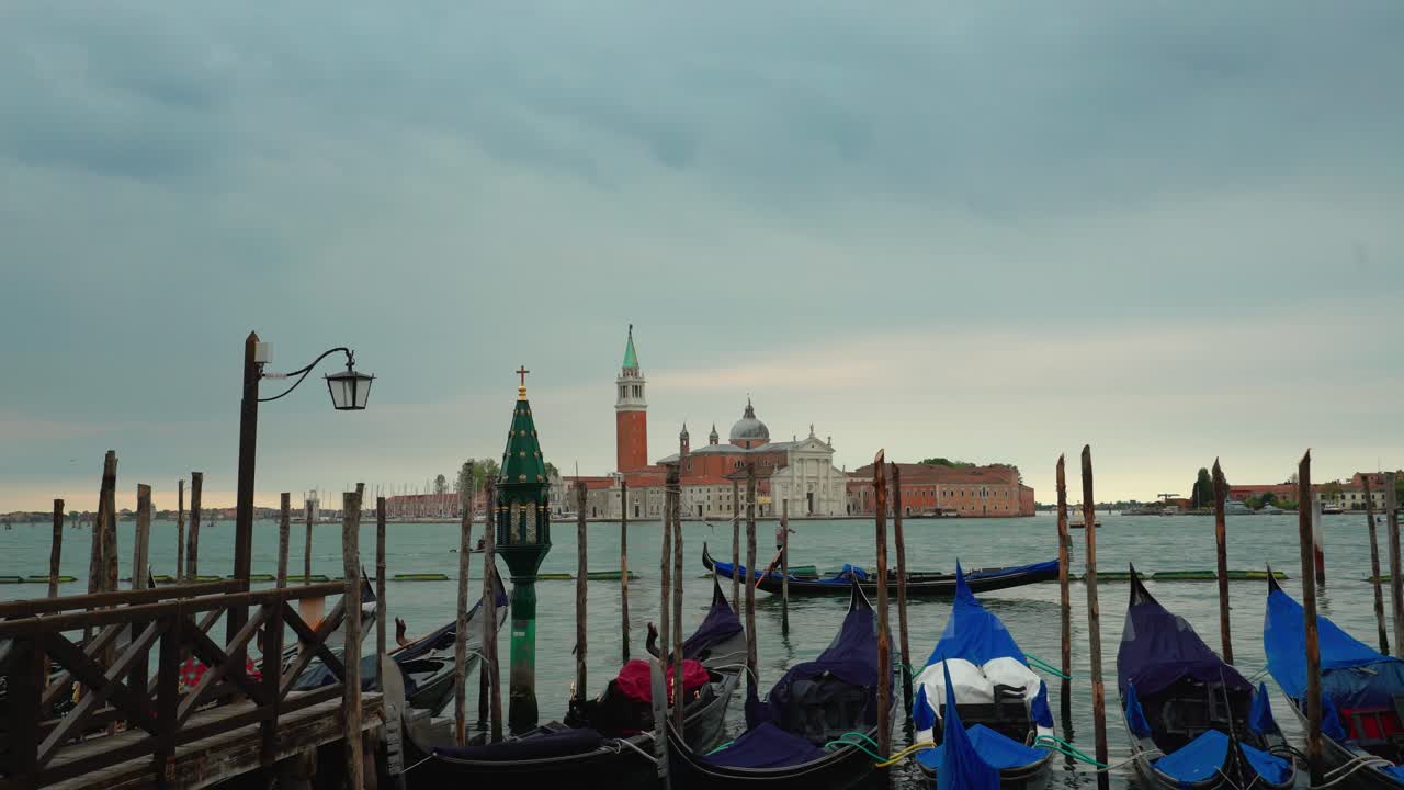 Venice Italy tourist holiday destination, view of gondola characteristics boat moored at gran canal in san marco square city center, with san Giorgio church in background