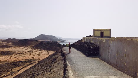 woman is admiring the scenic view of los lobos island in sunny weather