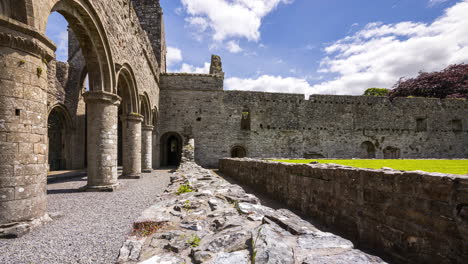 motion time lapse of boyle abbey medieval ruin in county roscommon in ireland as a historical sightseeing landmark with dramatic clouds in the sky on a summer day