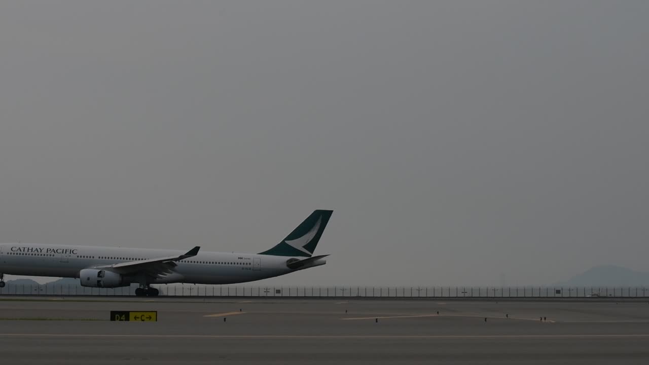 Cathay Pacific airplane landing on the runway at HKIA airport