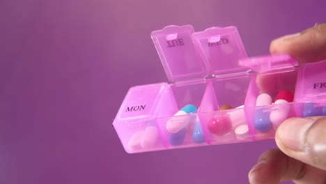 pink pill organizer with daily meds