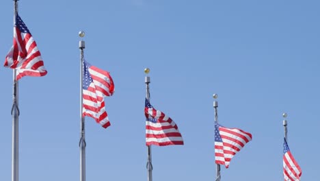 american flags waving in the wind in slow motion