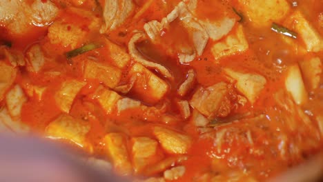 pov to the pot full of korean food -heated kimchi soup