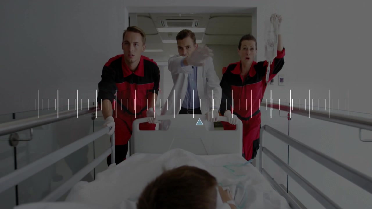 Equipe medica che entra e spinge un paziente bambino lungo il corridoio con parametri vitali animati per cure urgenti.