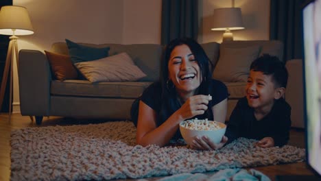 mother and son enjoying popcorn and a movie
