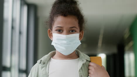 Schoolgirl-with-face-mask-in-school-corridor.