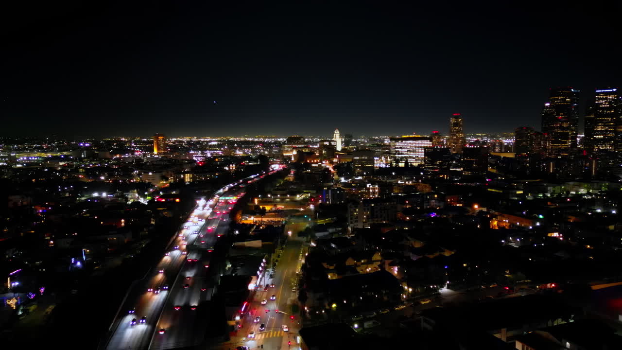 Aerial drone view of downtown Los Angeles illuminated at night
