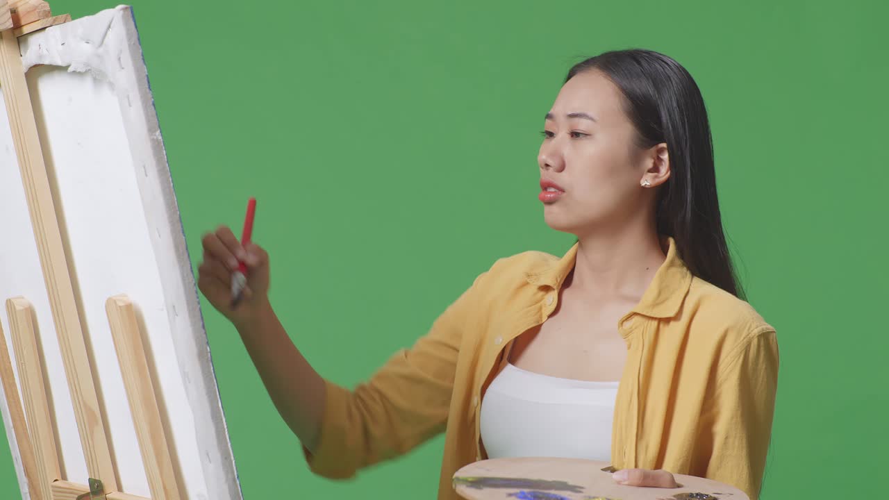 캔버스를 바라보는 여성 예술가