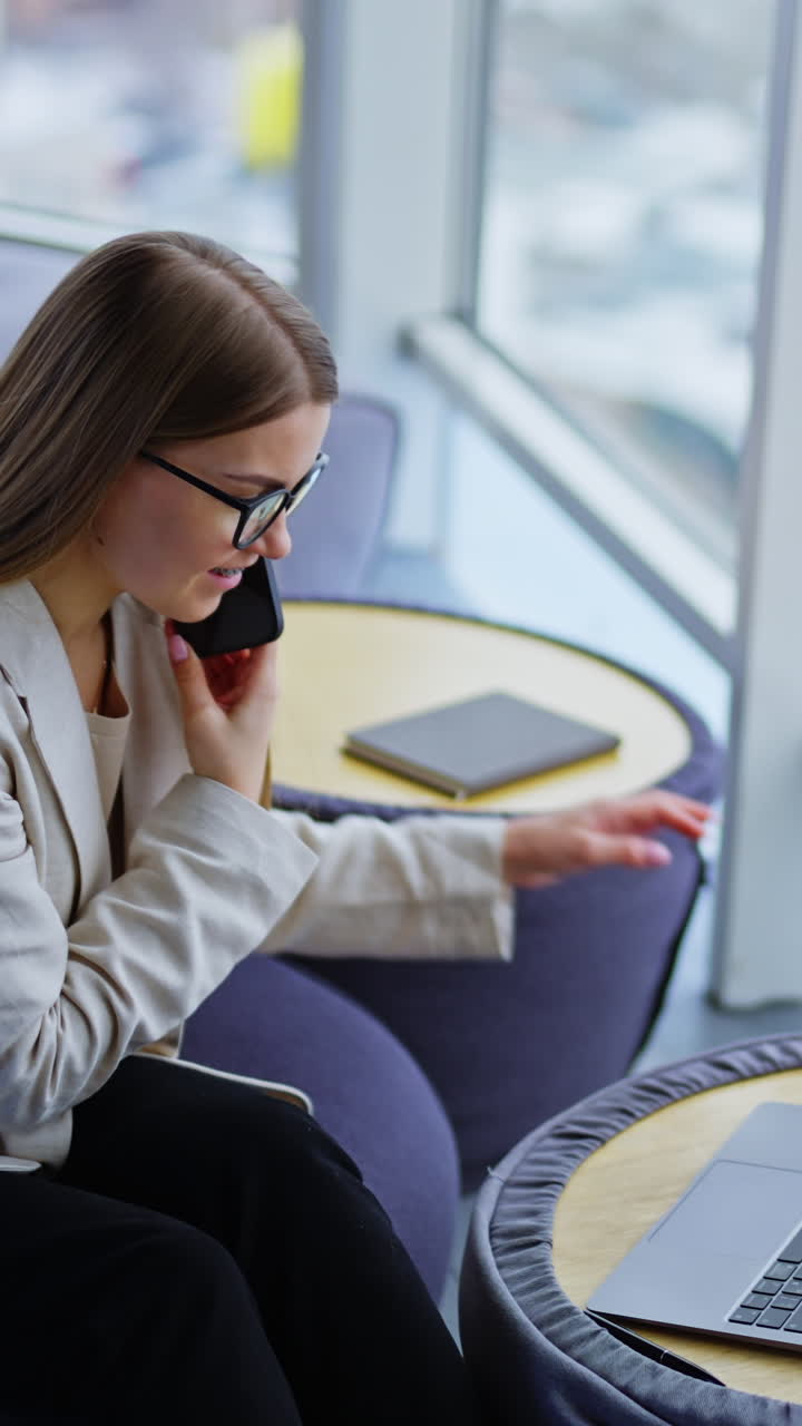 Beautiful young girl talking for business. Succesfull business lady having phone call. Vertical video