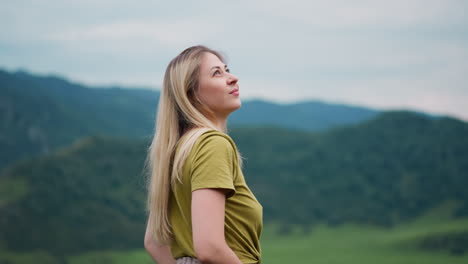 woman looks around holding hands in pockets at eco reserve