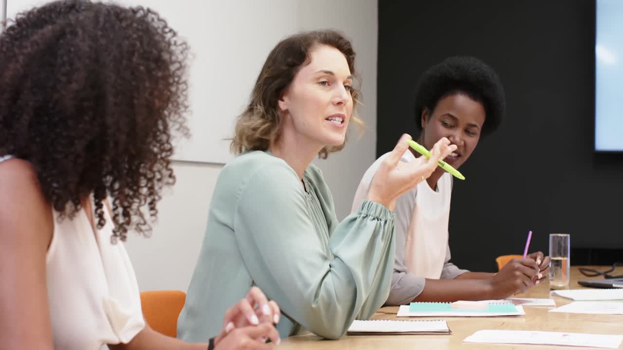 Diverse businesswomen having meeting and discussing work at office, in slow motion