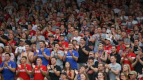 a vibrant crowd in unison: spectators eagerly applauding, their enthusiasm radiating throughout the venue, creating an electric atmosphere of excitement and unity