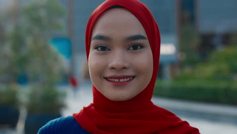 close-up portrait of a young muslim woman wearing a red hijab