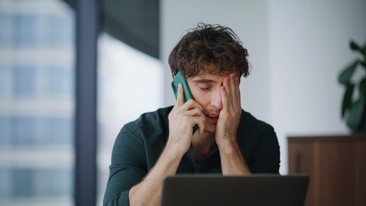 Worried boss speaking cellphone feeling tension at corporate workplace closeup